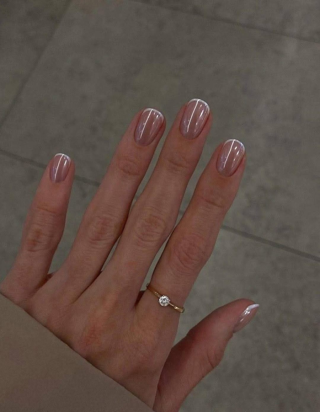 Minimalist nude nails with white line art, chic and understated.