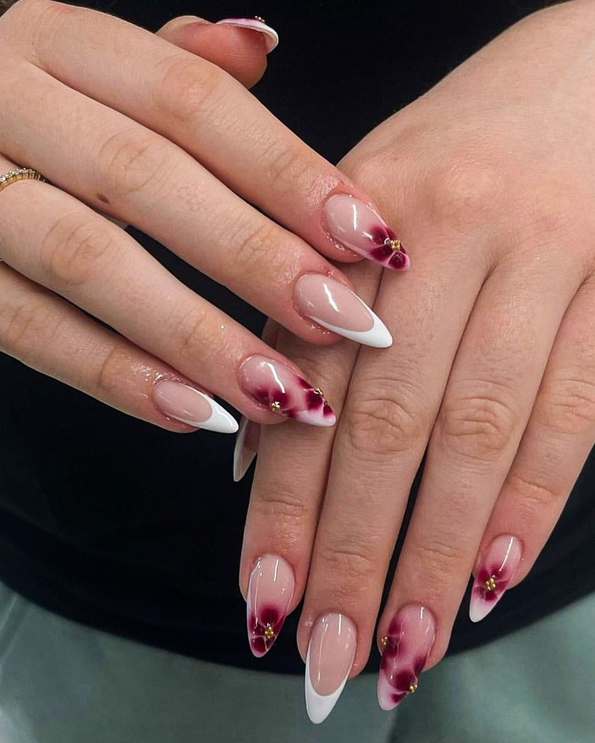 Almond French and floral nail art combination, elegant and artistic.