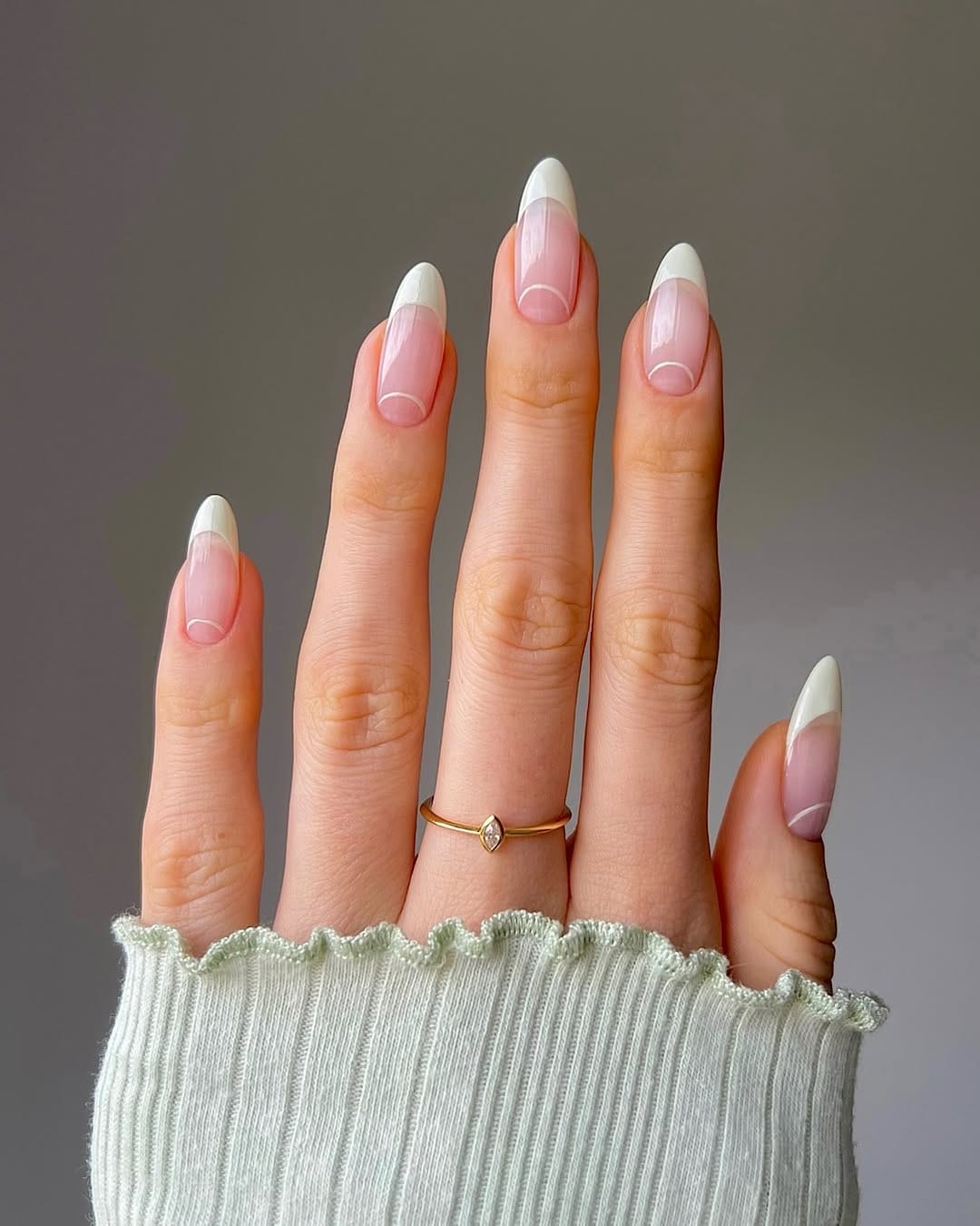 Classic almond white French tip nails.