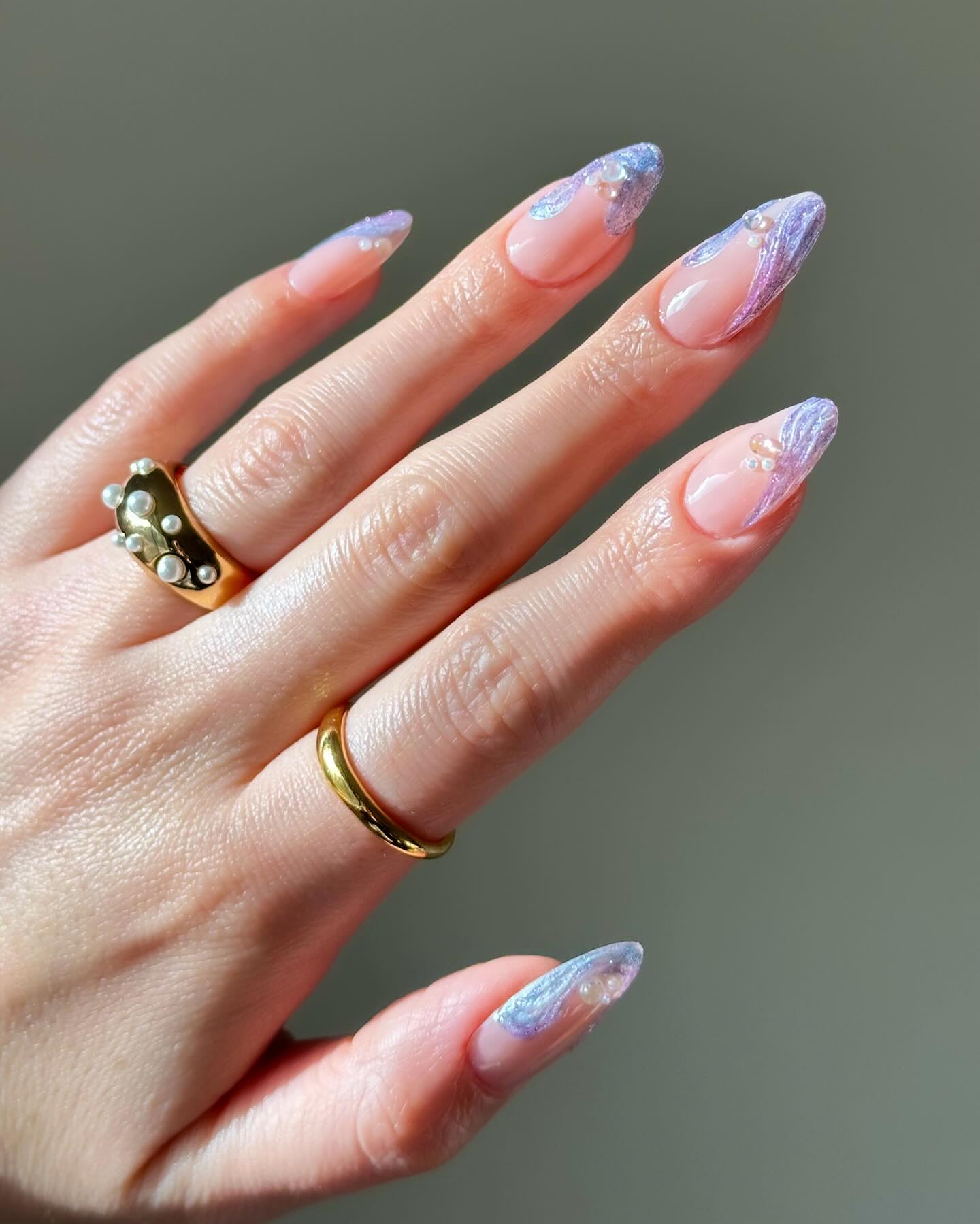 Almond lavender glitter French tip nails.