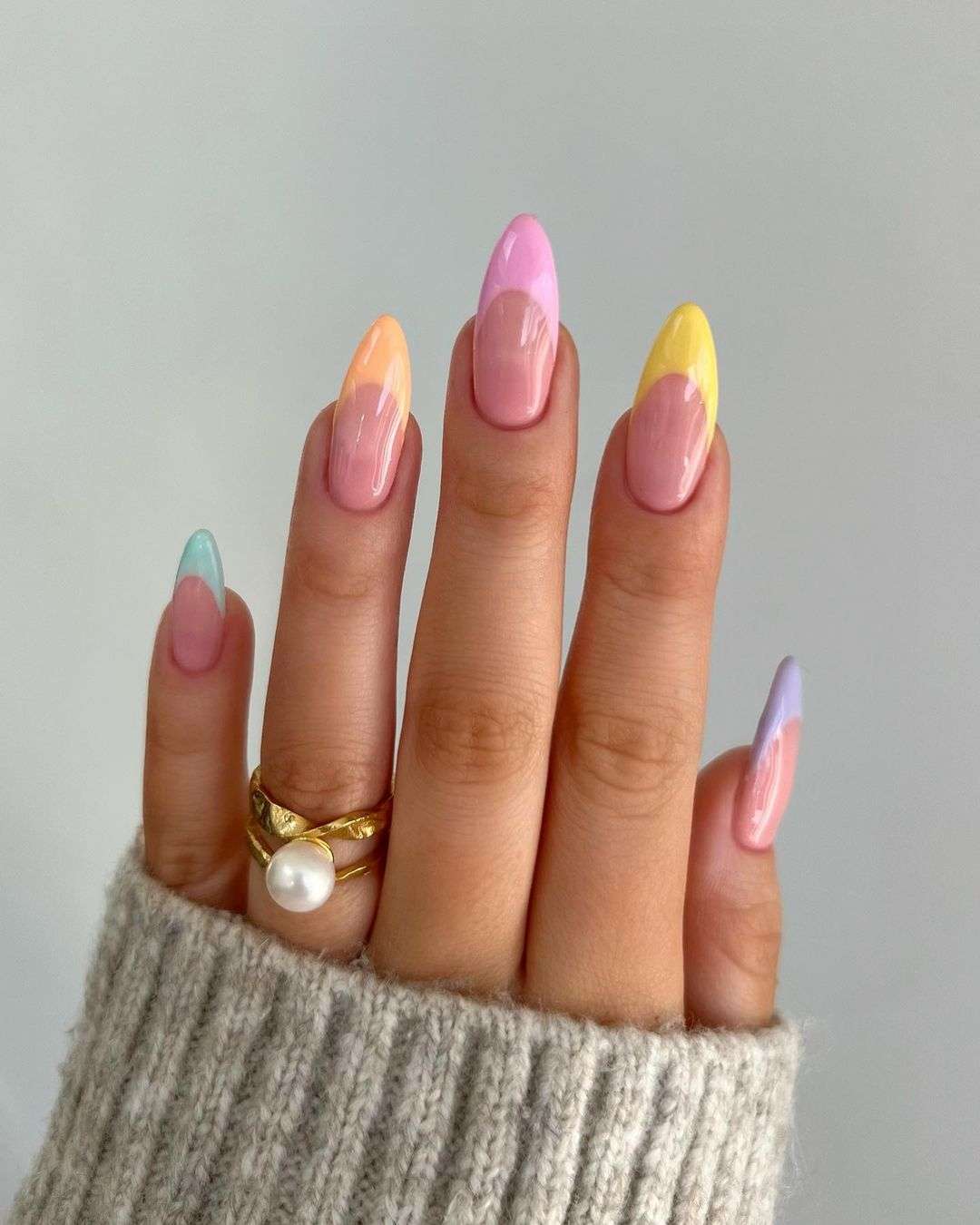 Almond rainbow French tip nails.