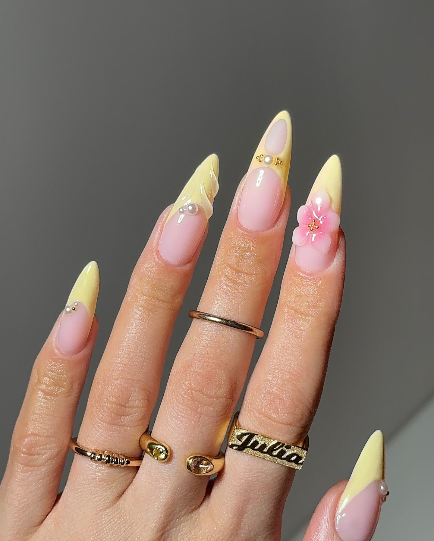 Stiletto yellow floral French tip nails.