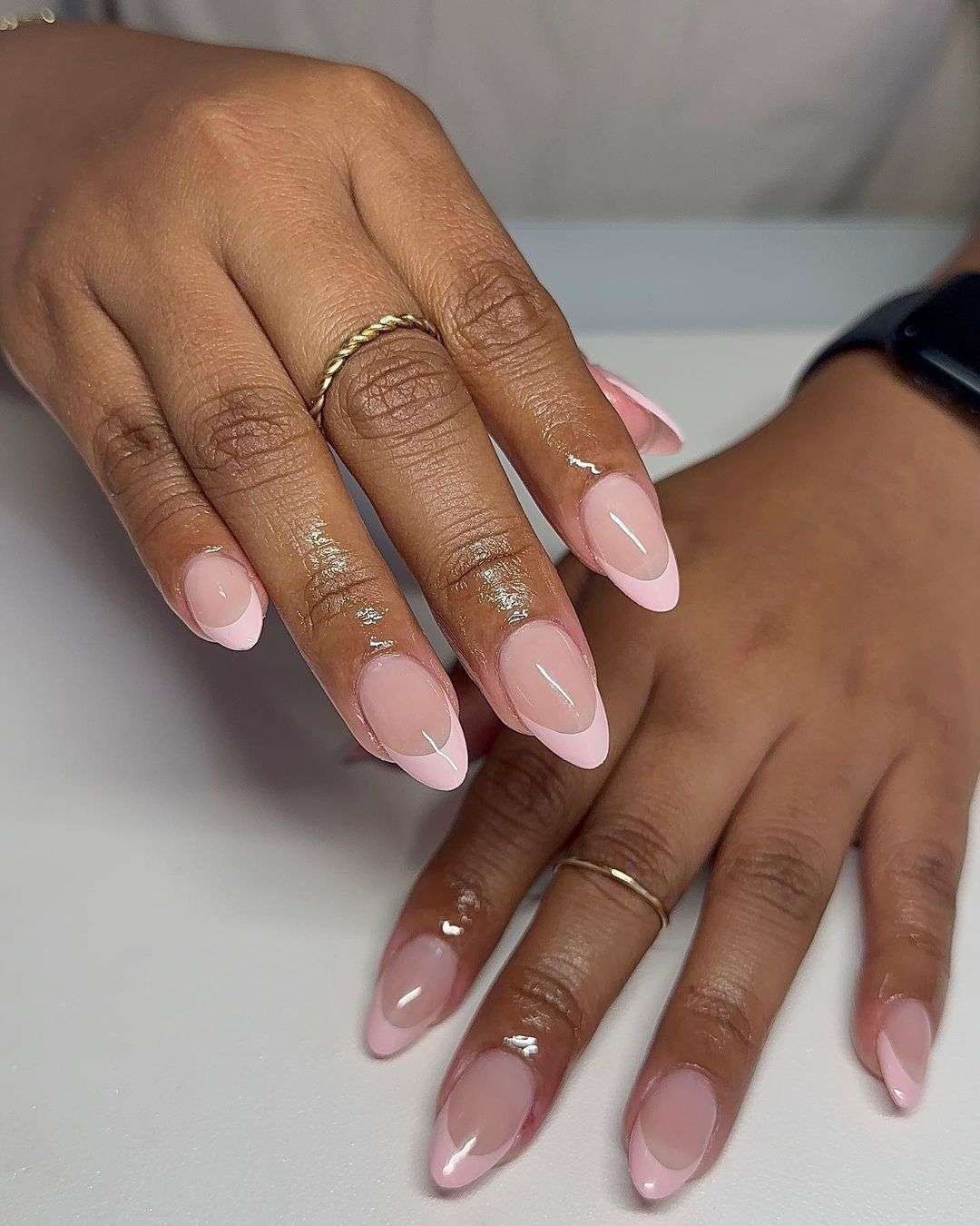 Almond soft pink French tip nails.
