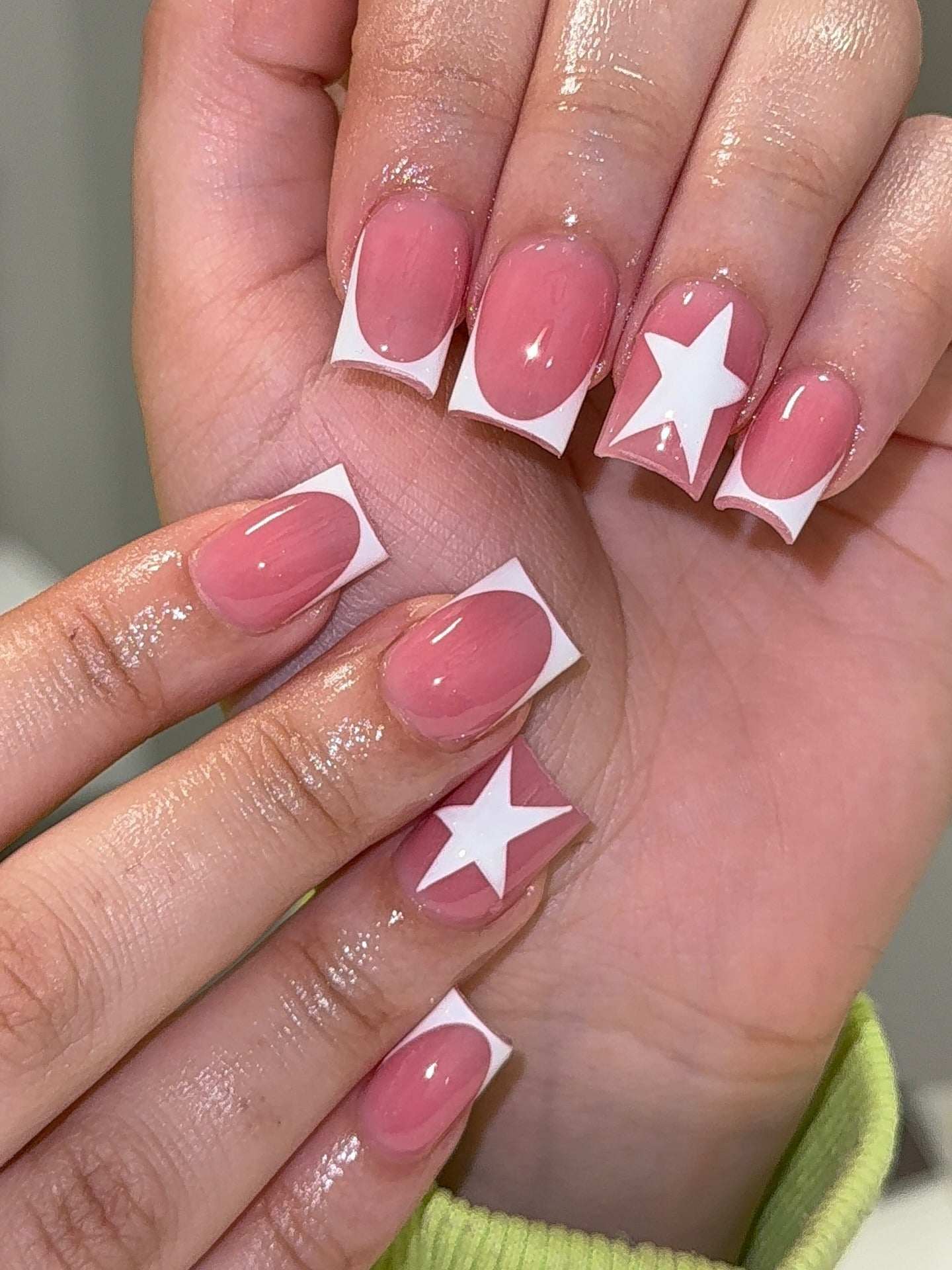 Square pink French tips with white star design.