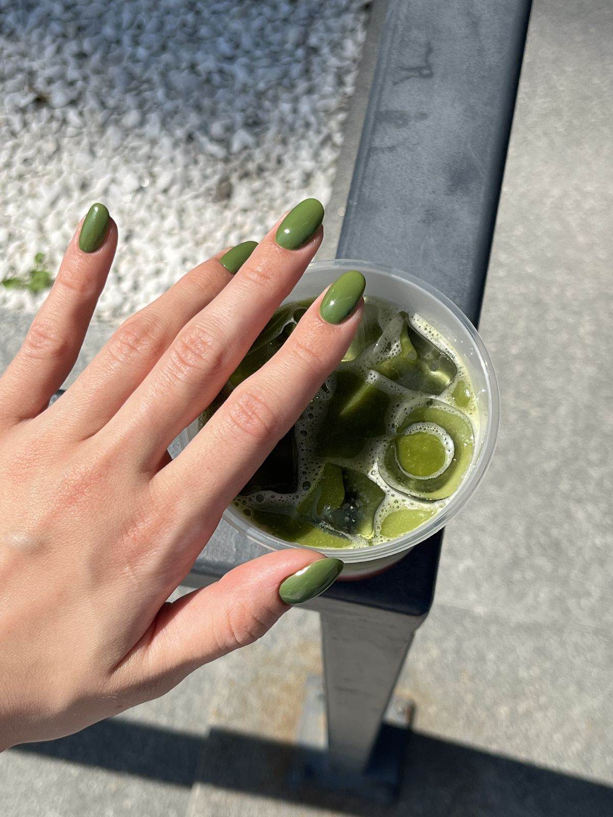 Short oval olive green nails.