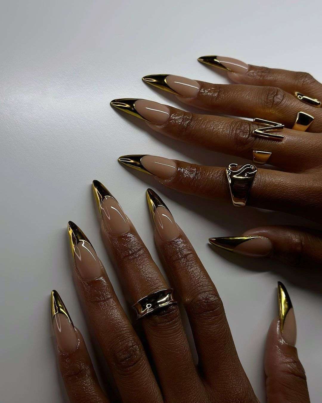 Stiletto black and gold French tip nails.