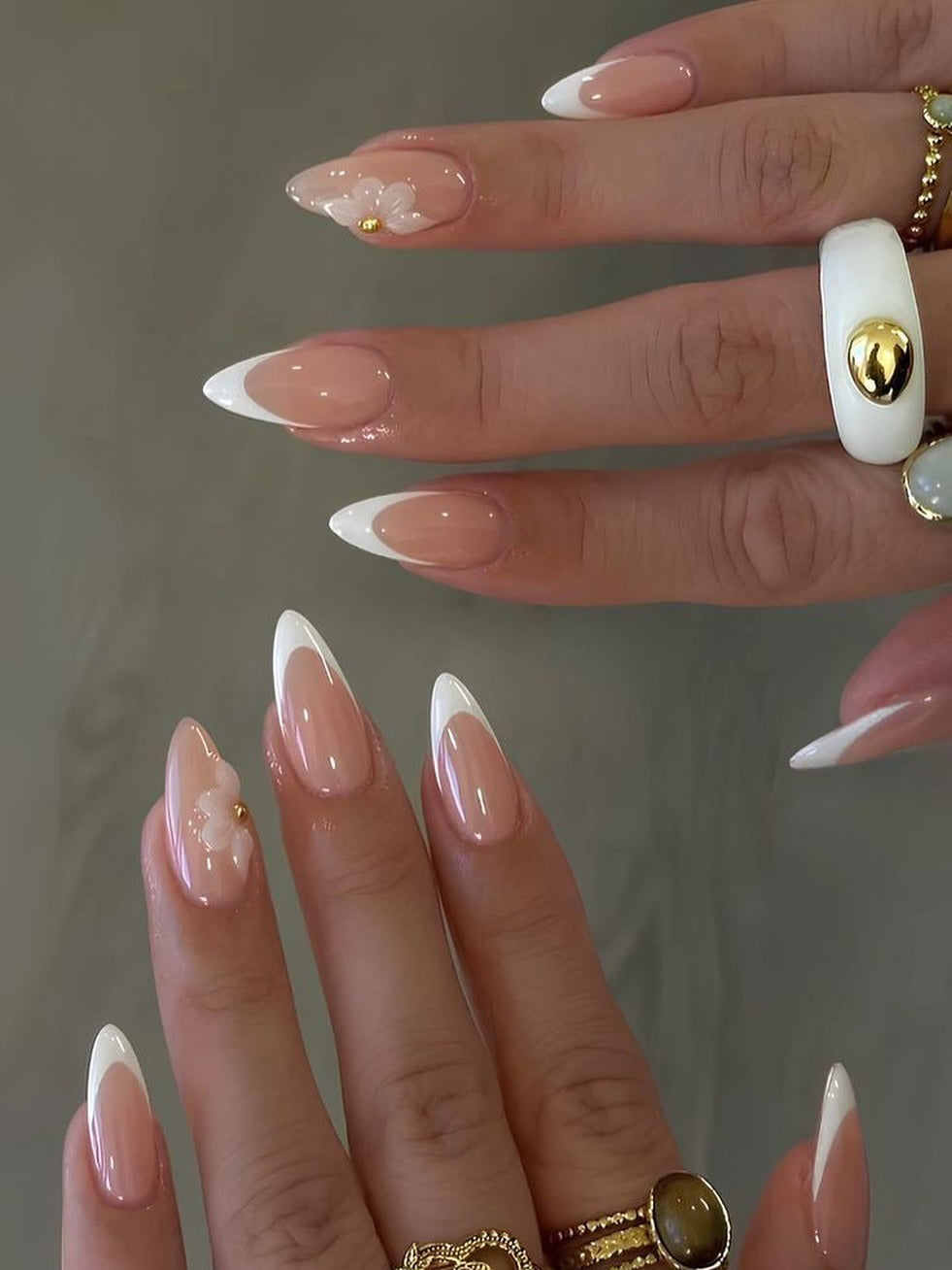 Almond French tips with floral accents.