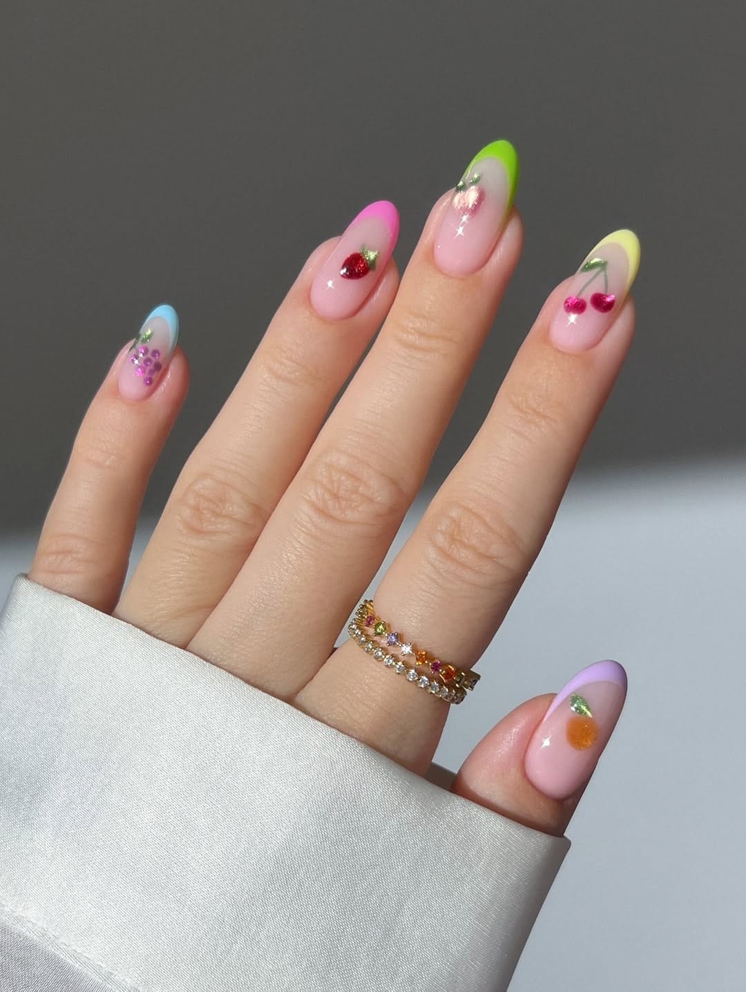 Almond colorful fruit French tip nails.