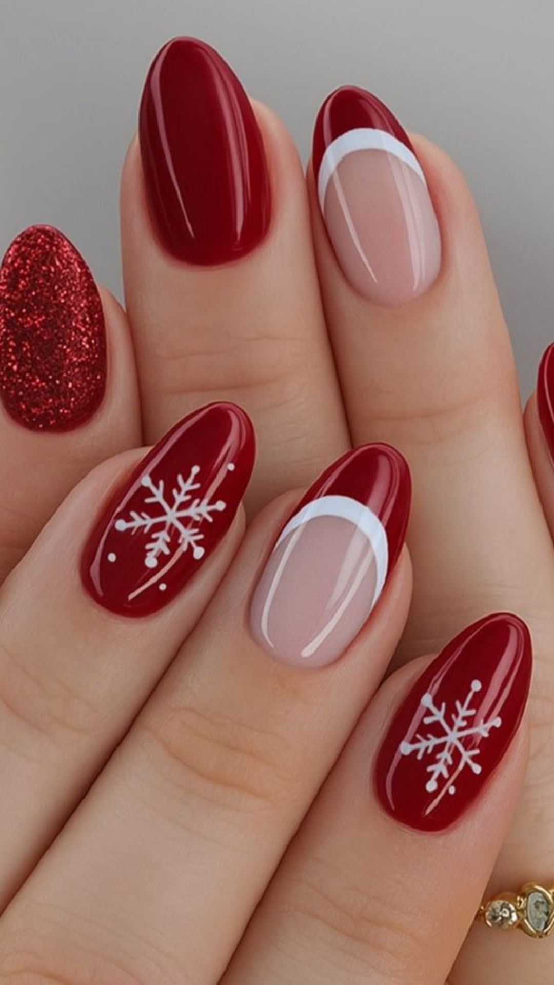 Festive red nails with snowflake art and glitter, holiday-ready.