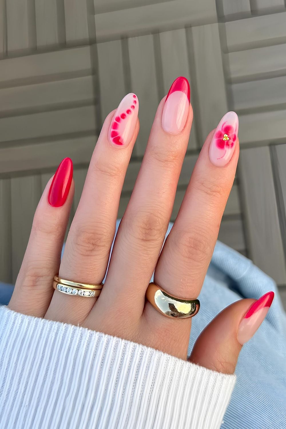 Playful red nails with petal art, fun and trendy.