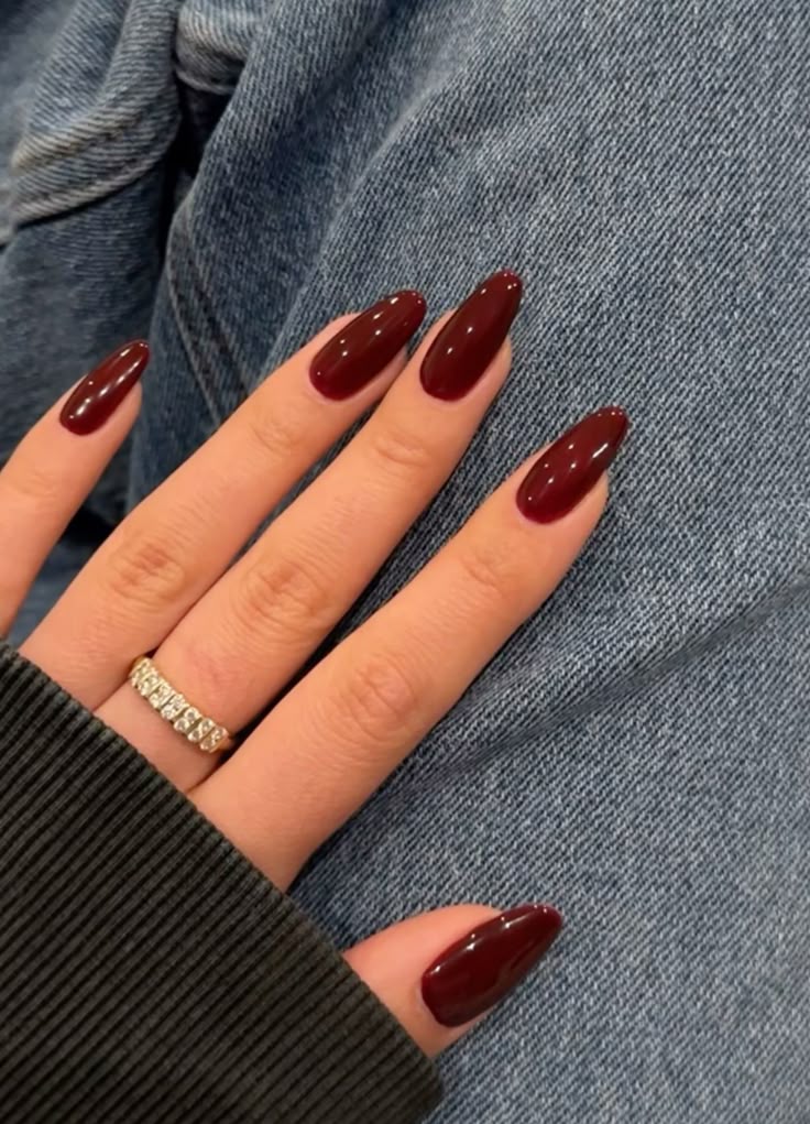 Rich maroon almond nails, classic and elegant.