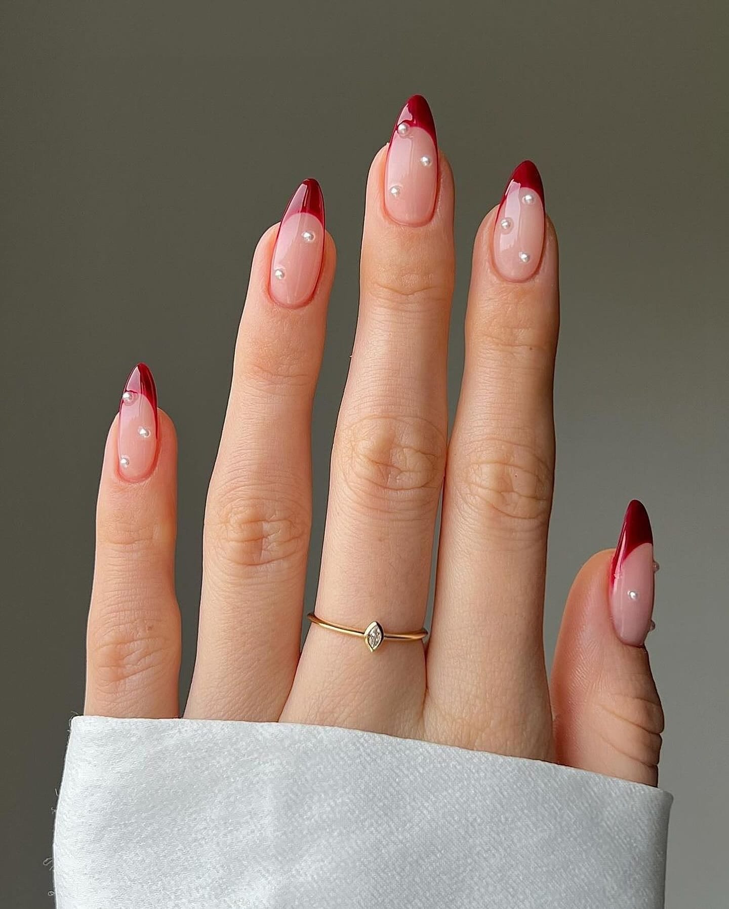 Burgundy French nails with pearl dots, elegant and modern.