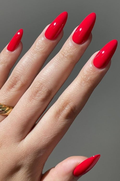 Bold red almond nails, striking and elegant.