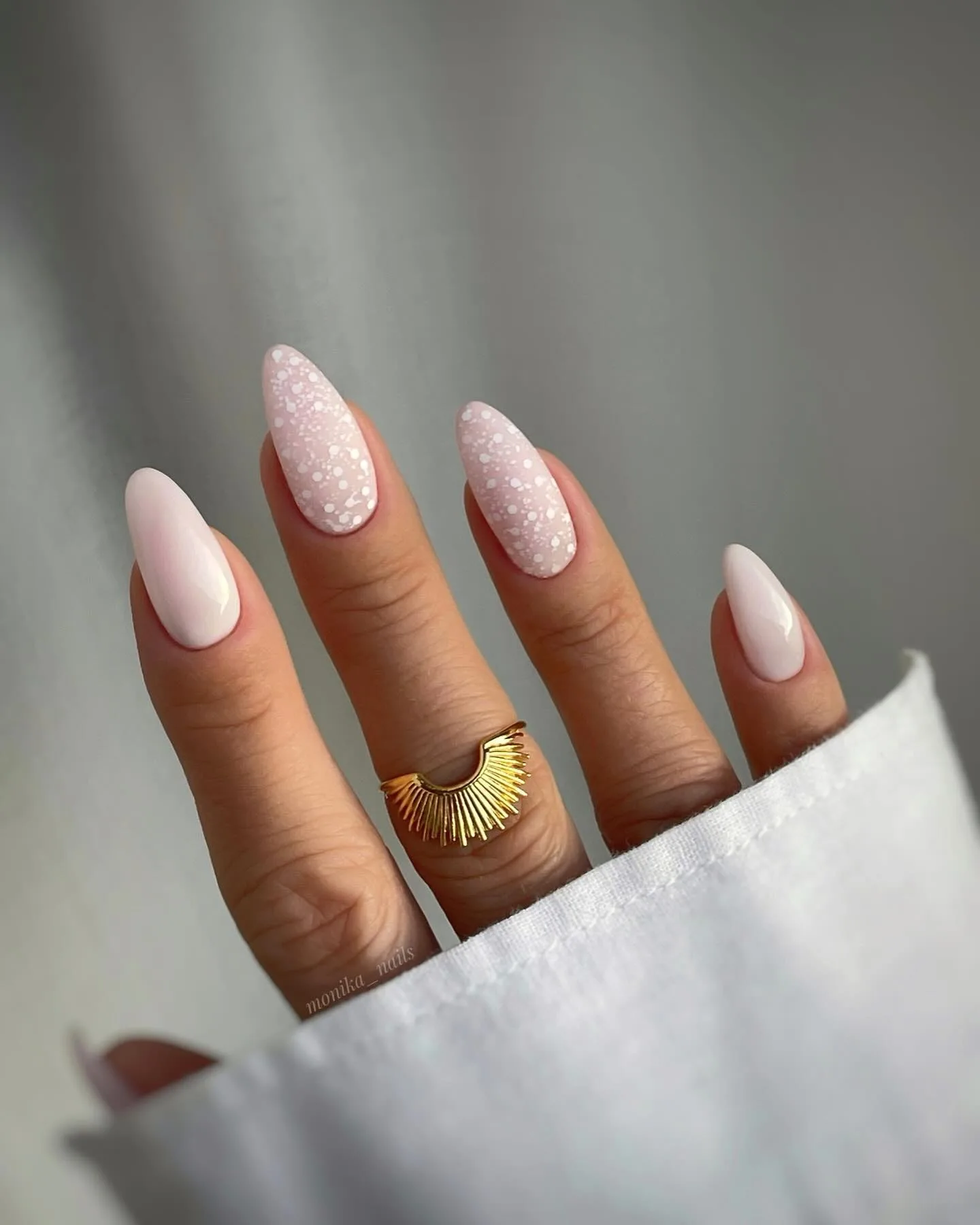 Soft pink nails with white polka dots