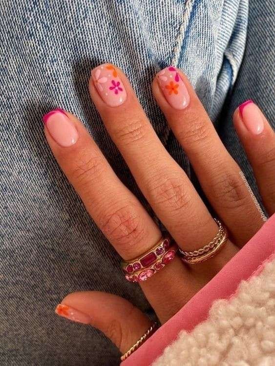 Pink French tips with floral accents