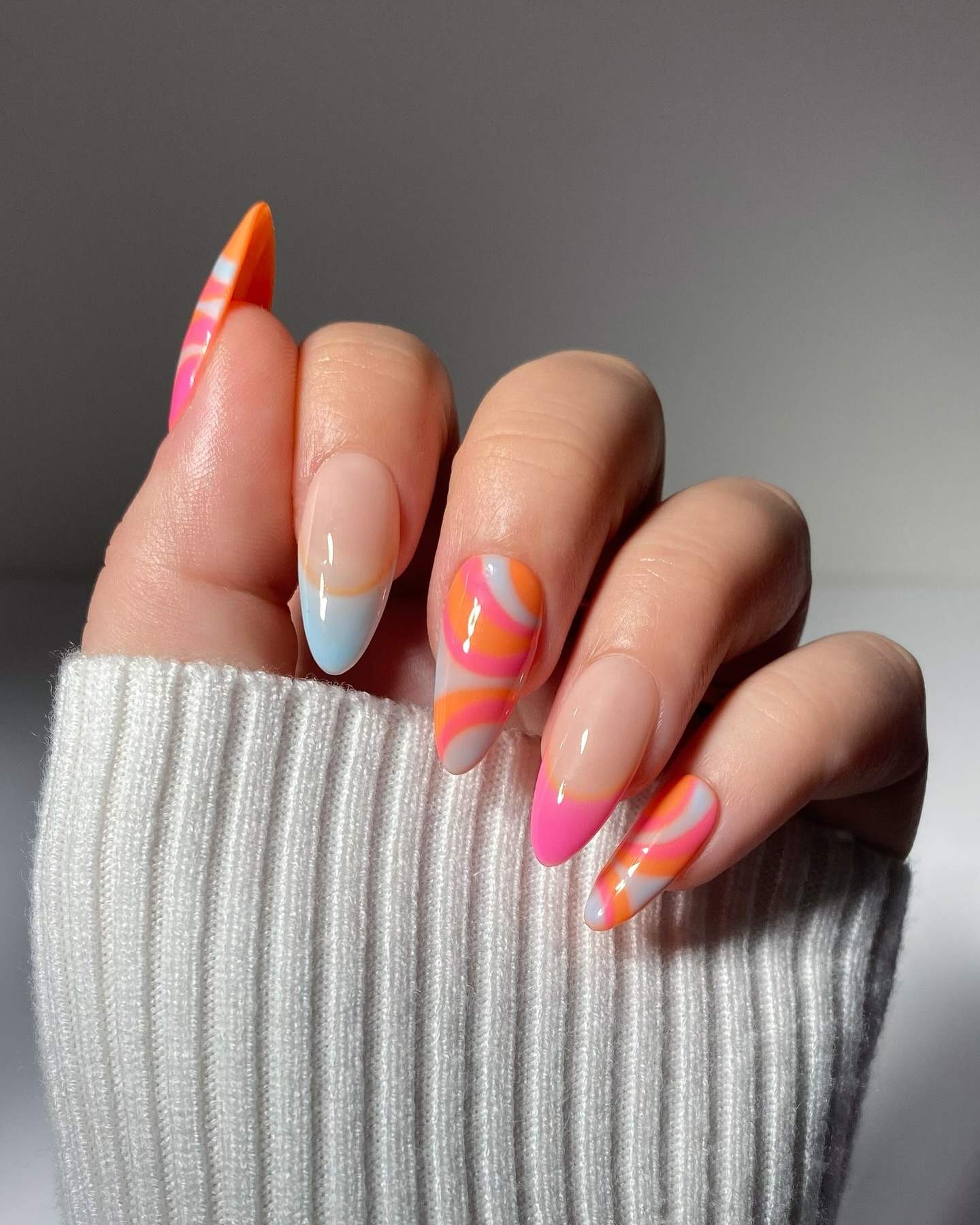 Abstract swirl nails in pink and orange