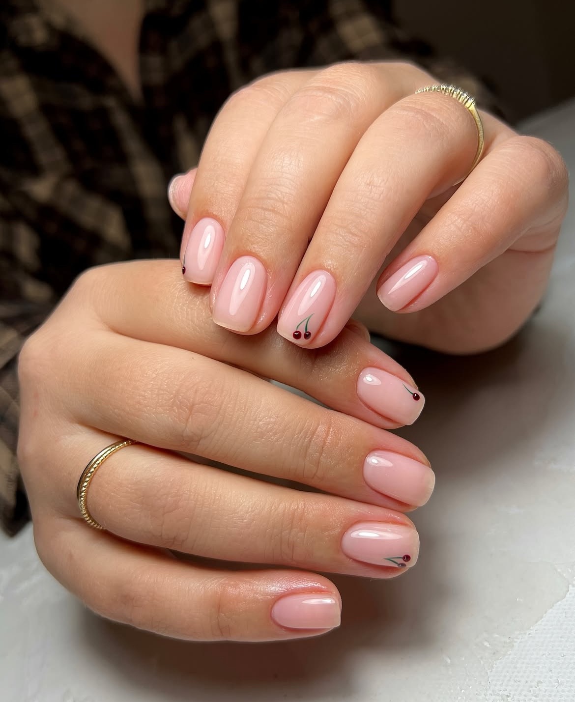 Short pink nails with small petal details
