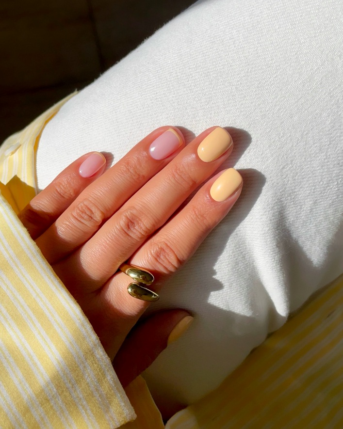 Short peach and pink nails with glossy finish