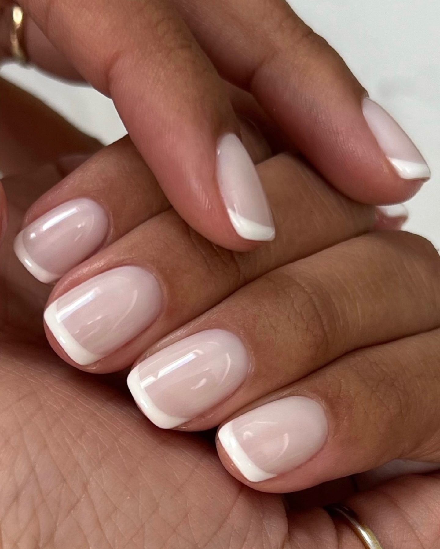 White french tip nails with french acrylic nails and dark feminine nails, blue nail inspo colored with dark blue tip.