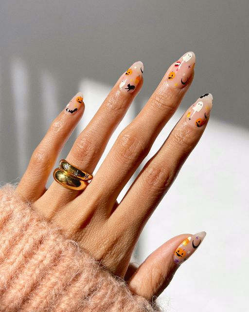 Pink halloween nails featuring halloween character nails, fall nail inspo, simple witchy nails, spooky elements.