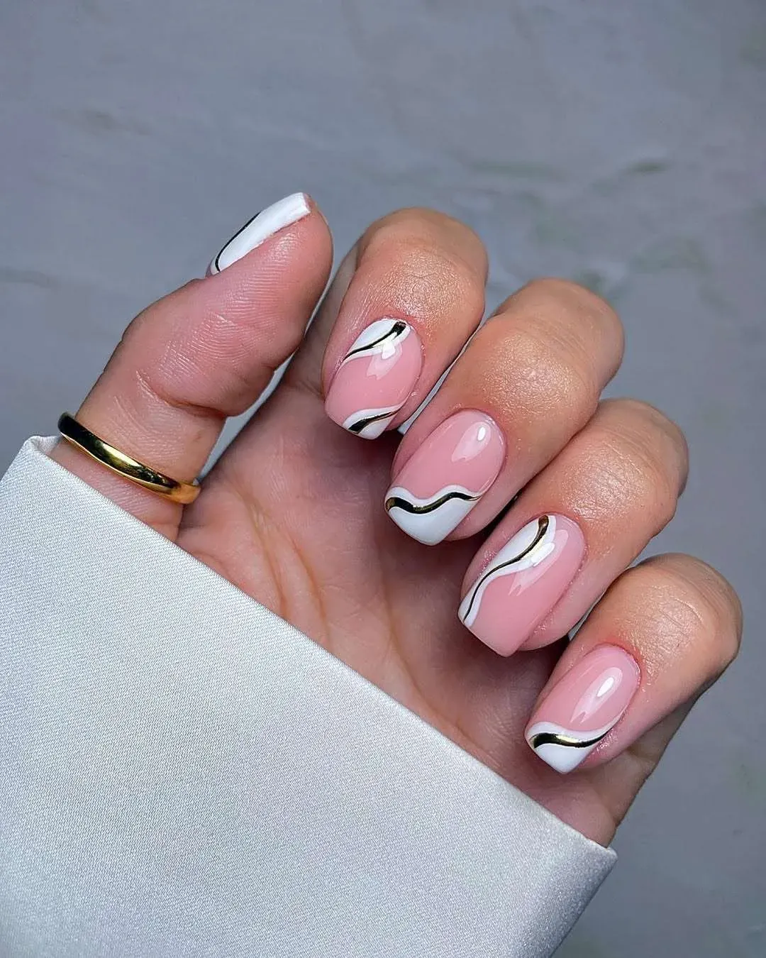Pink nails with black and white wave accents