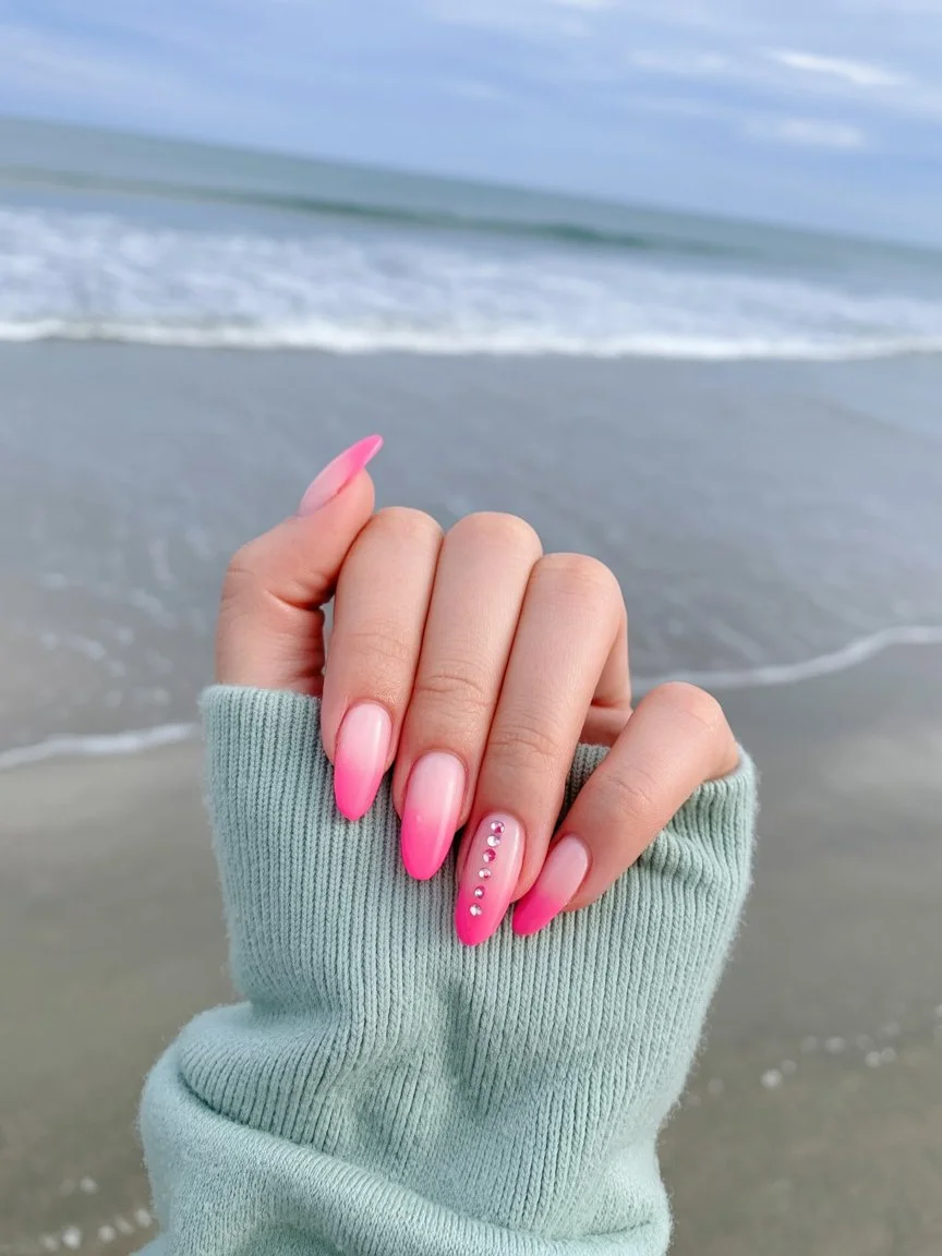 Pink ombré nails with rhinestone accents