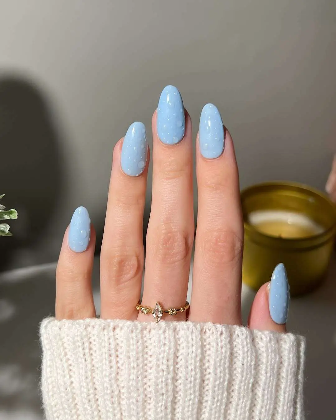 Light blue nails with white polka dots