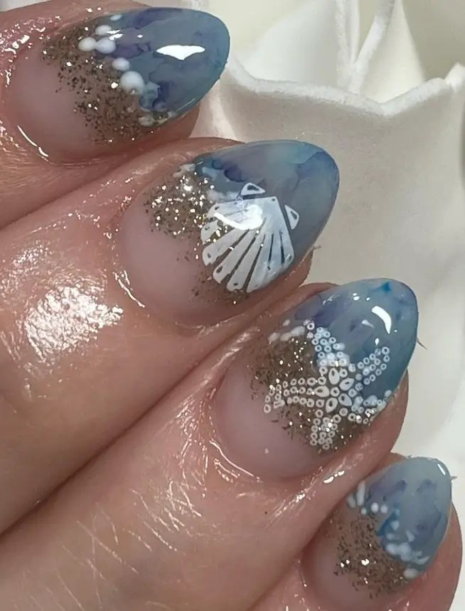 Blue ocean nails with shell and glitter accents