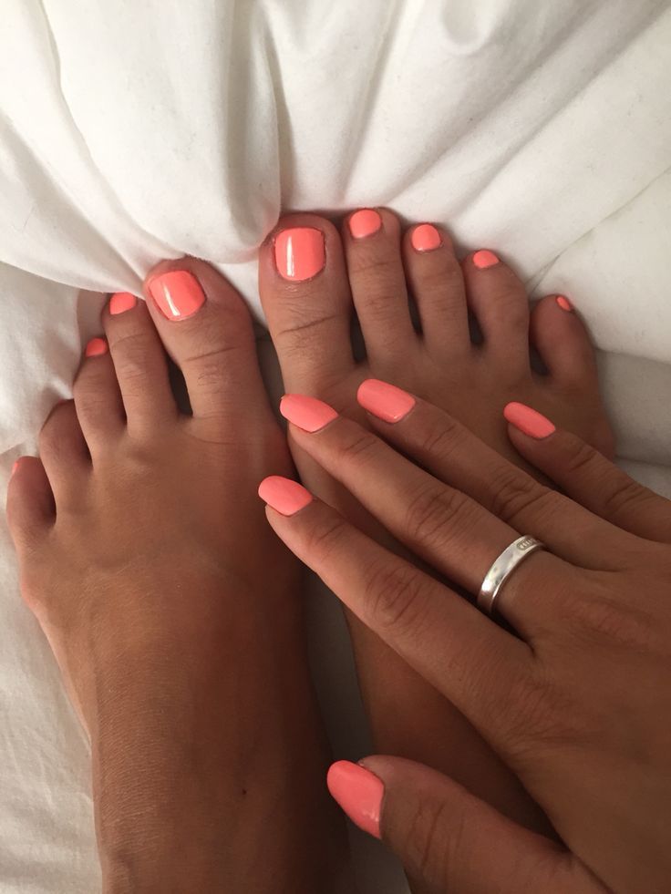 Coral manicured fingers and toes with almond shape