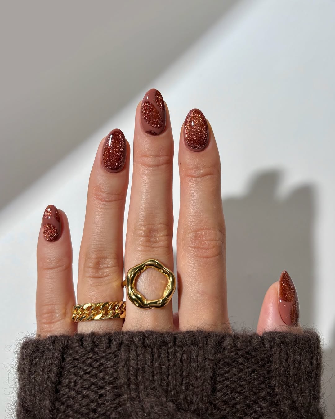 deep brown nails with orange highlights
