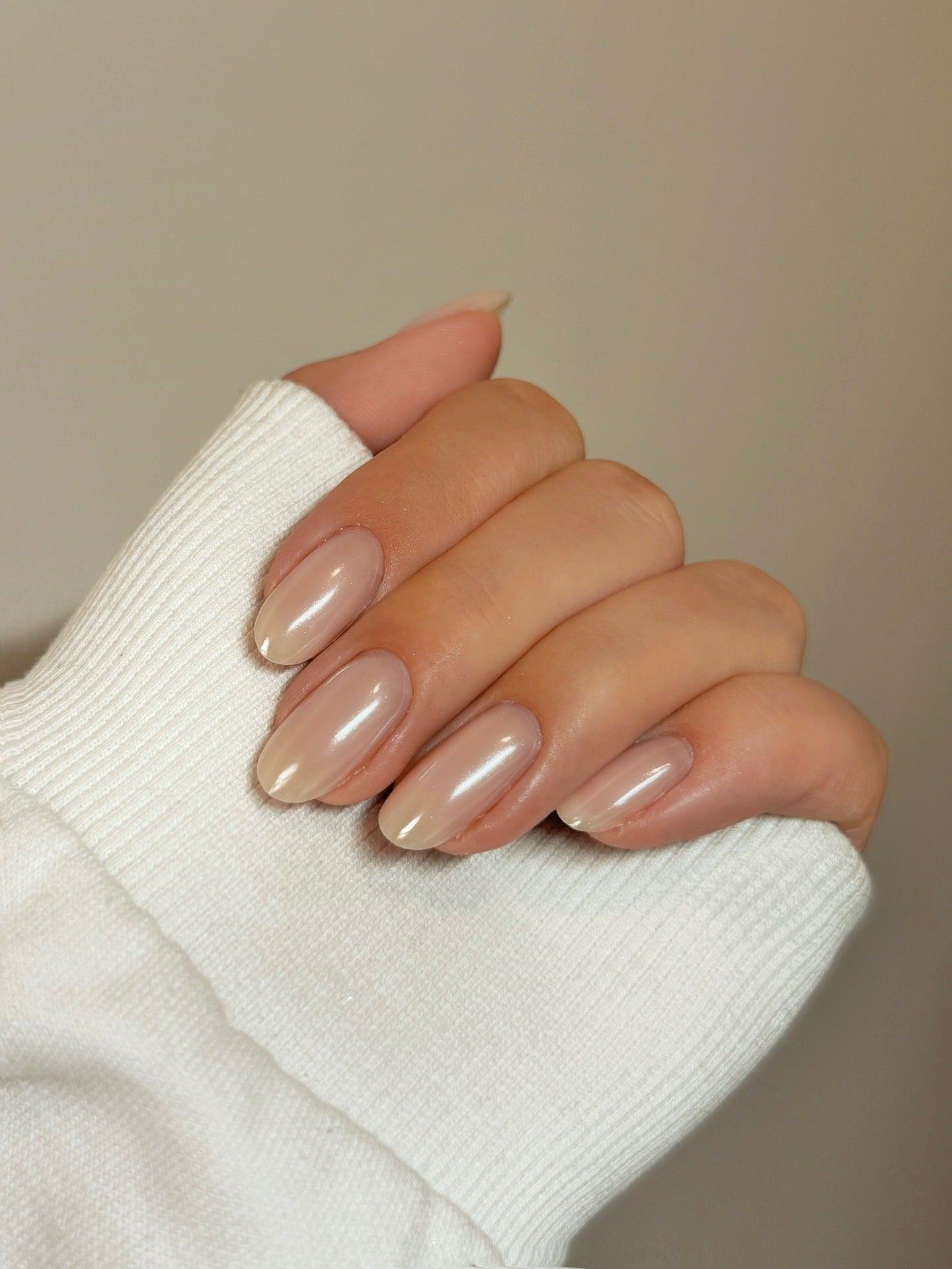 Sheer pearl almond nails with glossy shine