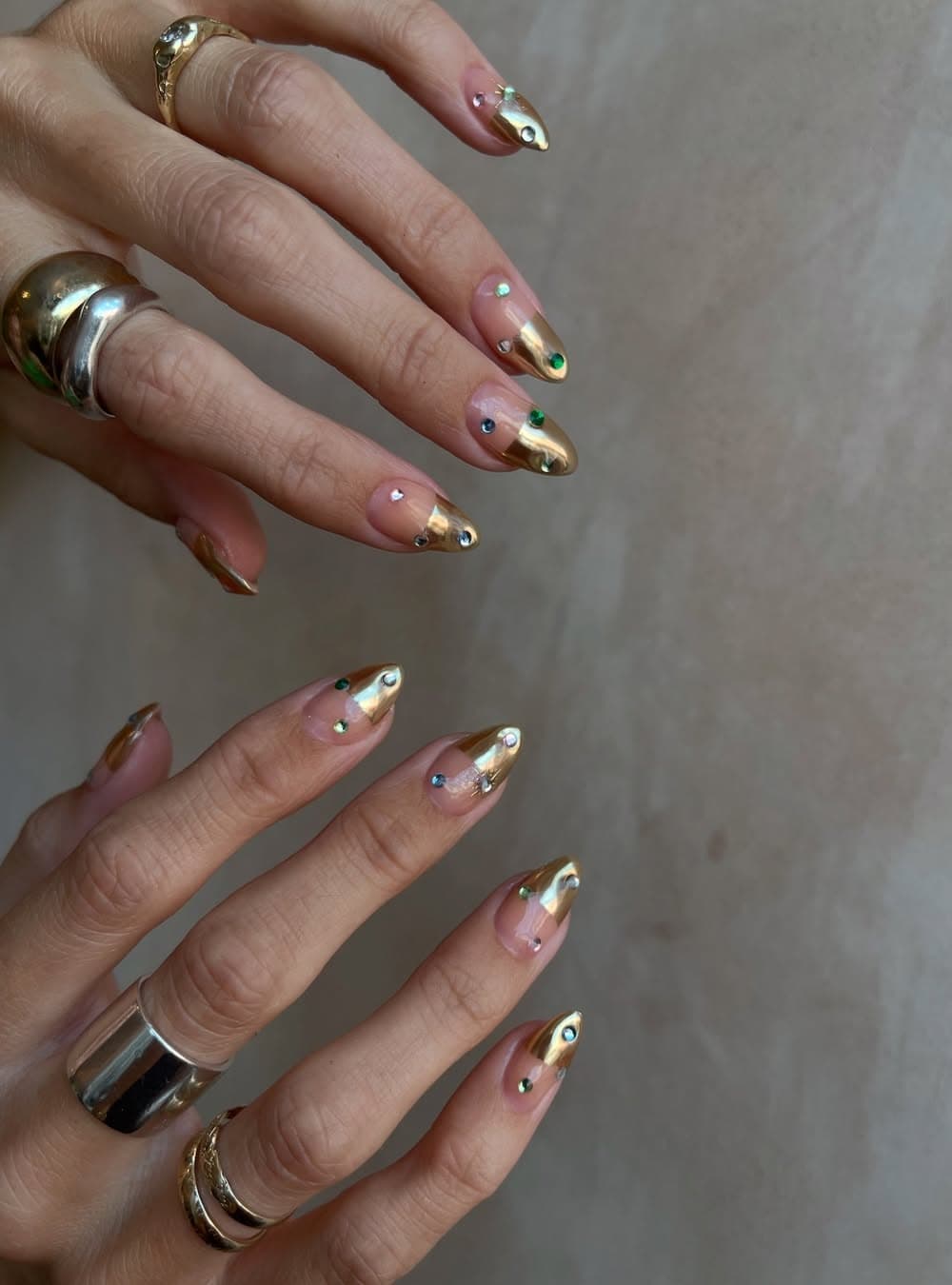 Almond nails with golden metallic tips