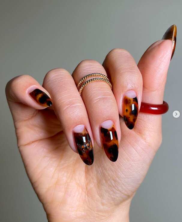 Pink nails with holiday nail designs in square shape.