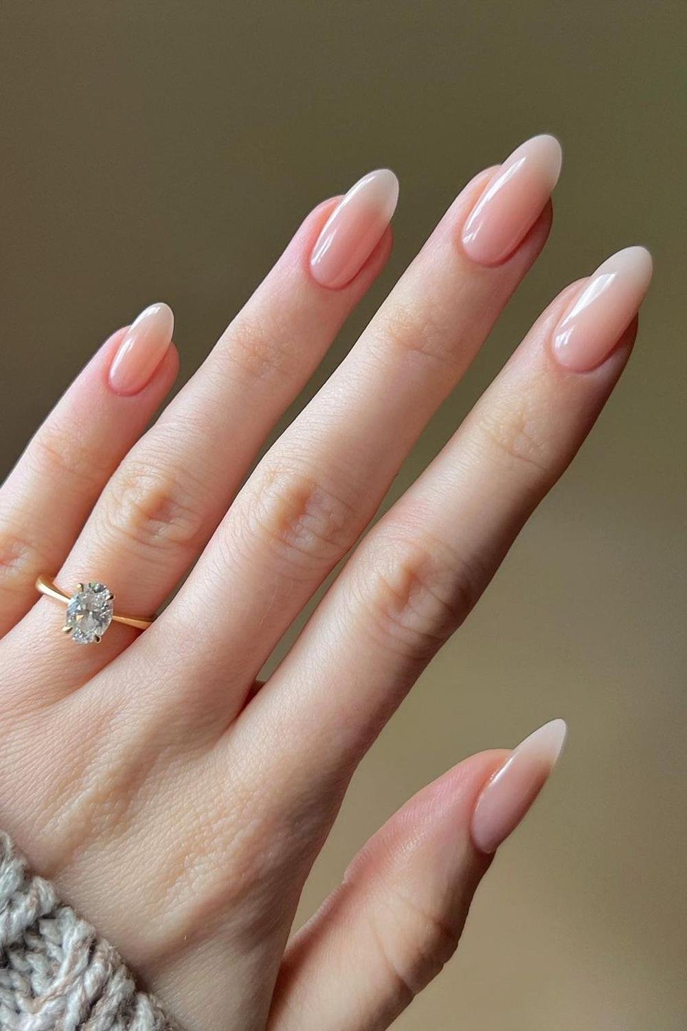 Nude acrylic nails with almond design featuring milky pink gel and neutral ombre in chrome almond.
