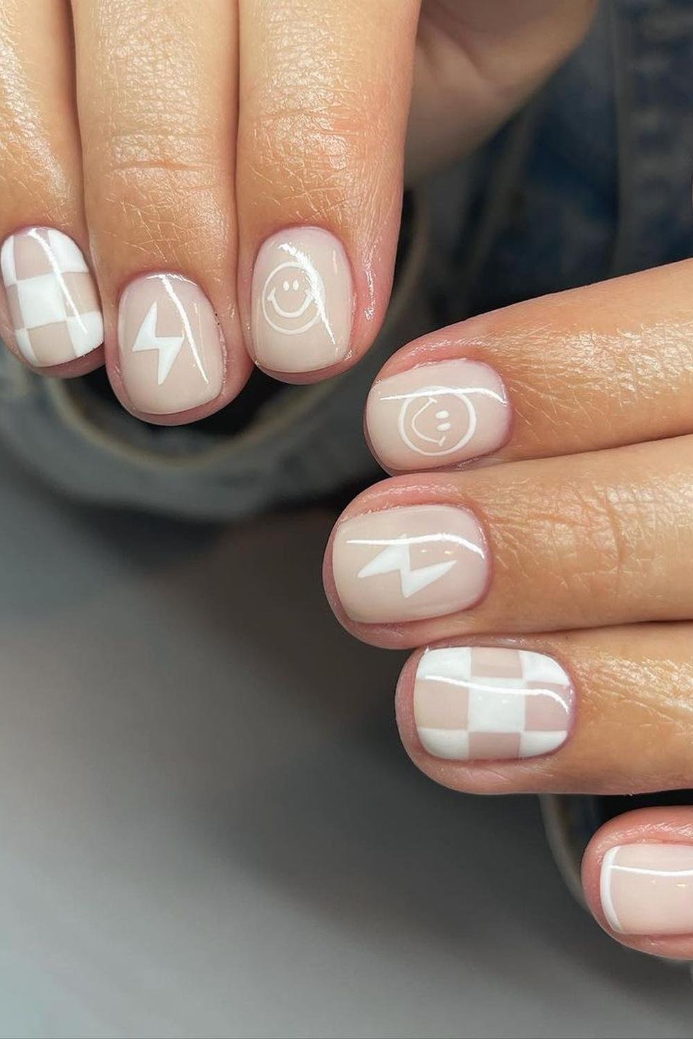 Nude french tip nails with pink nude sparkly accents in hailey bieber style for black nails ideas.