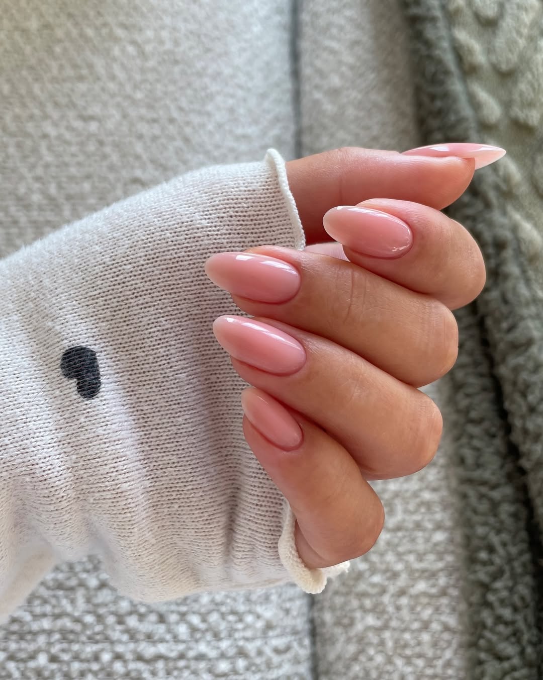 Nude and white nails with light pink round short color and red accents.