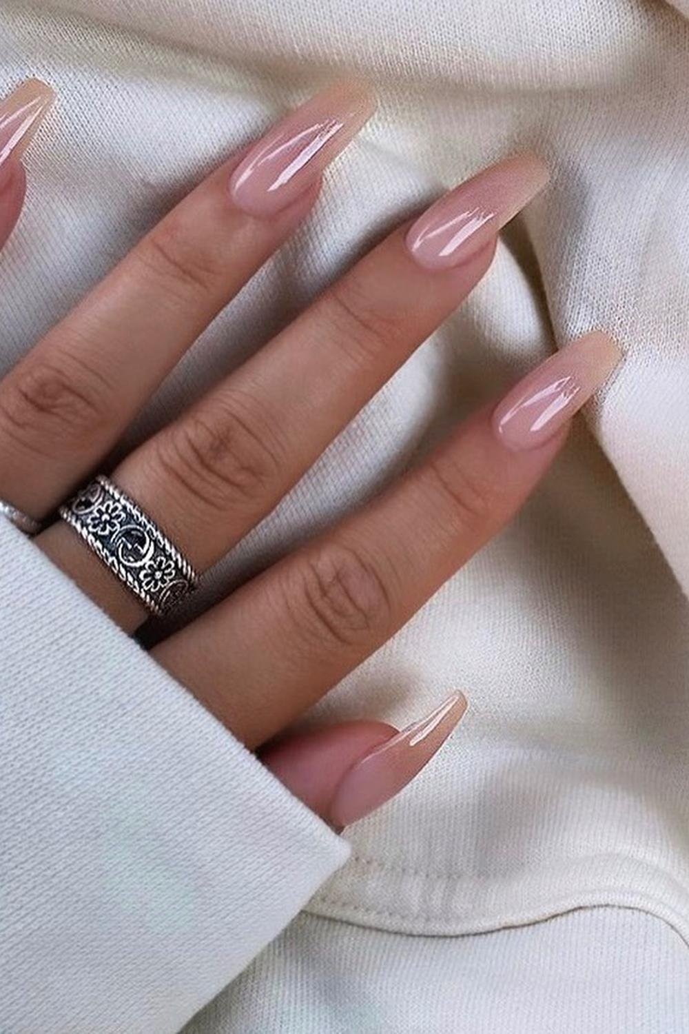 Nude nails for black women with pink acrylic and neutral cat eye elegant design with flowers.