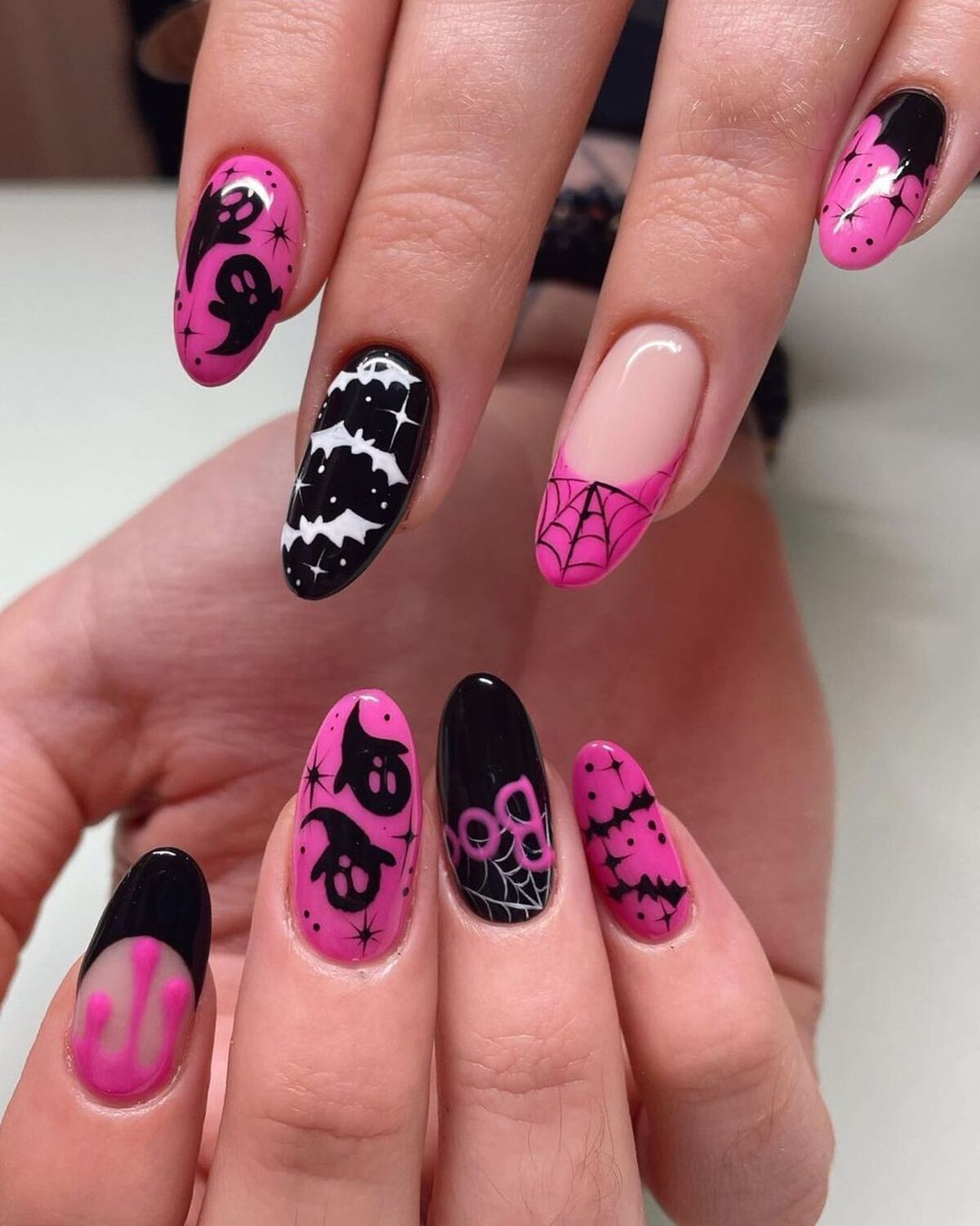 Easy halloween nails with pink halloween nails with ghosts, showcasing effortlessly spooky charm.