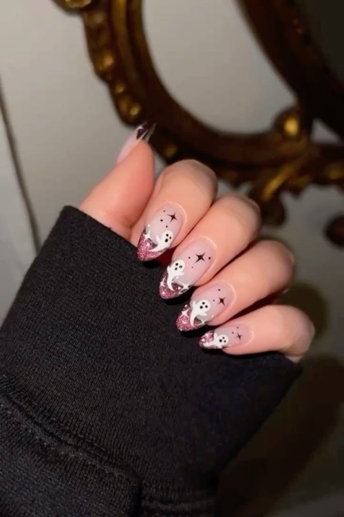 Cute halloween nail designs with pink nails october theme.
