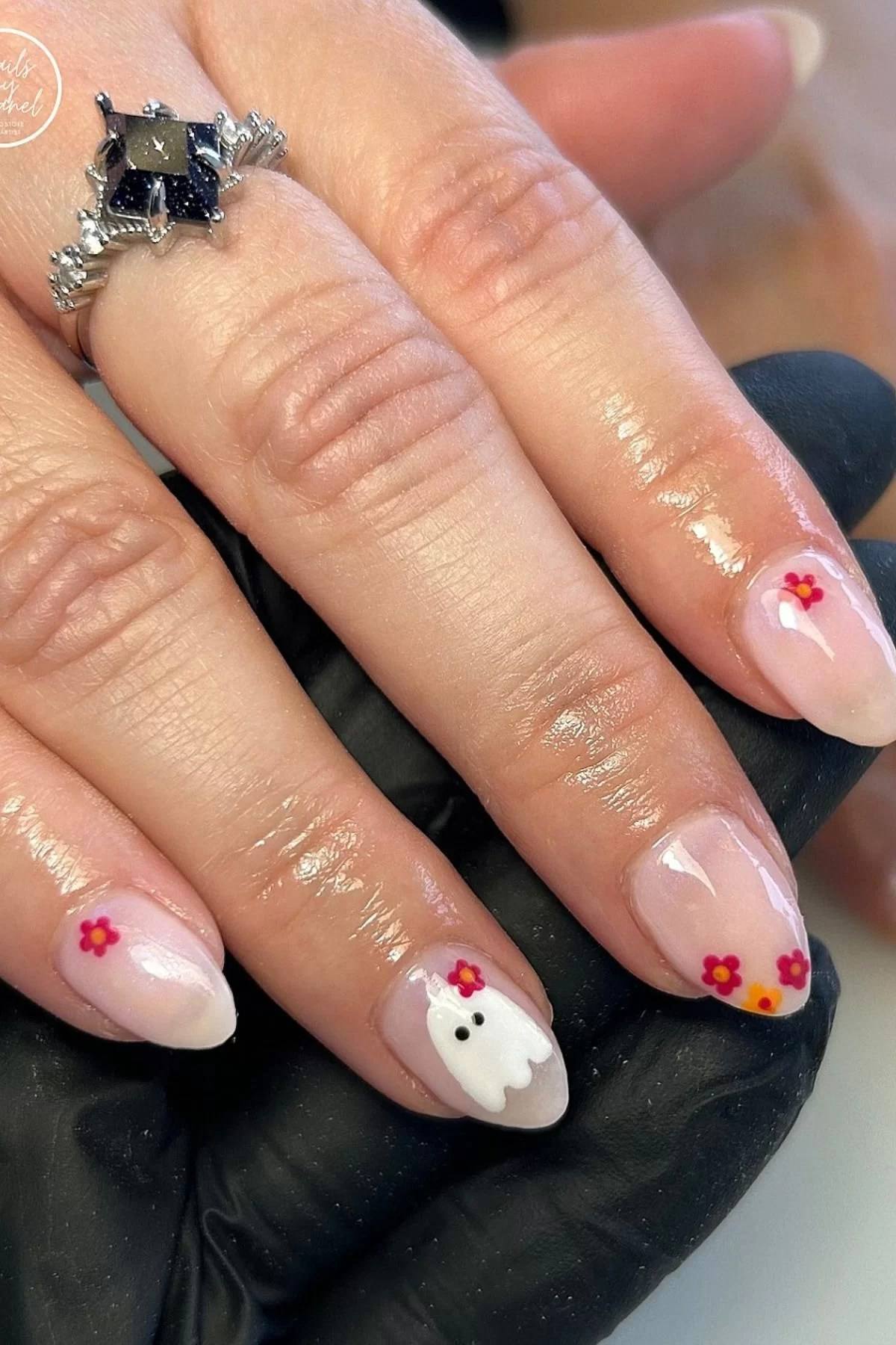 Pink spooky nails with pink and brown halloween nails.