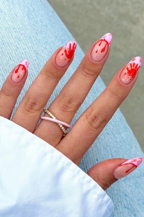 Fun halloween nails with dripping red accents.