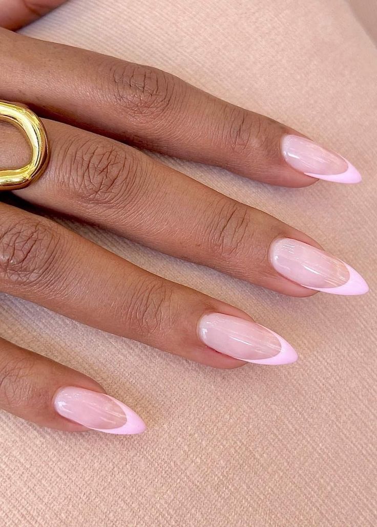 Milky pink nails paired with pink and brown nails, light pink french tip, elegant almond nails, and floral orange accents.