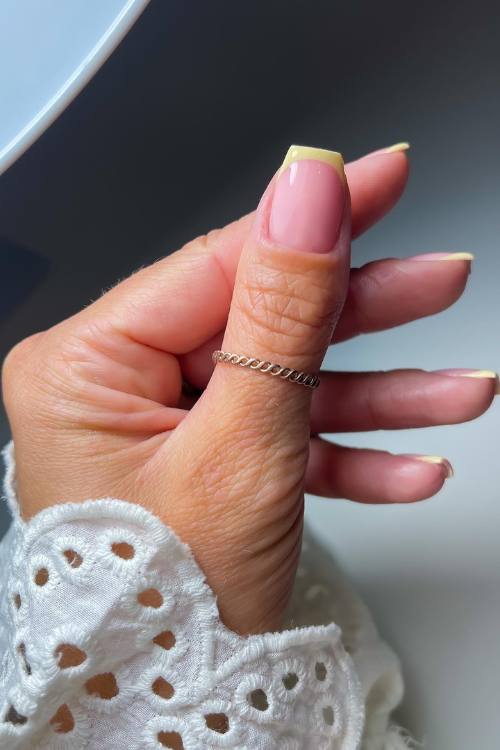Dark pink nails with baby pink nails with design, featuring winter nail inspo with french and purple accents.