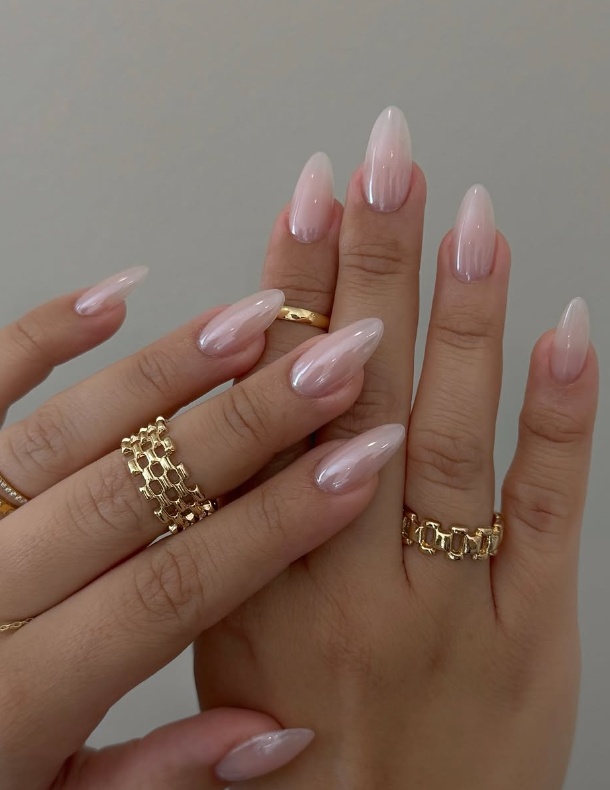 Pink valentines day nails with pink fairy nails, featuring milky nails with design and orange light with accents.