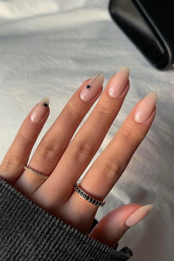 Minimalist halloween nails with subtle spider detail