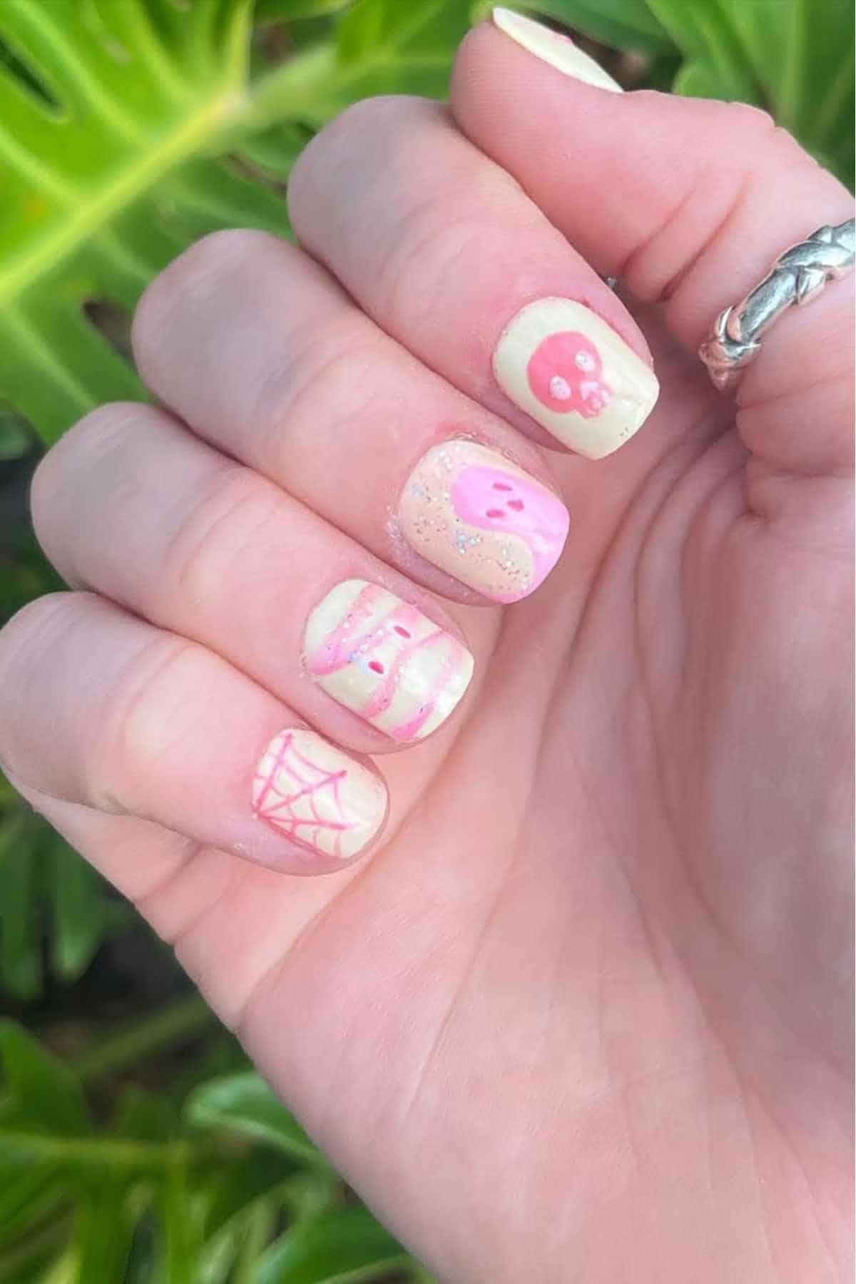 Pastel Halloween nails with ghost and web motifs