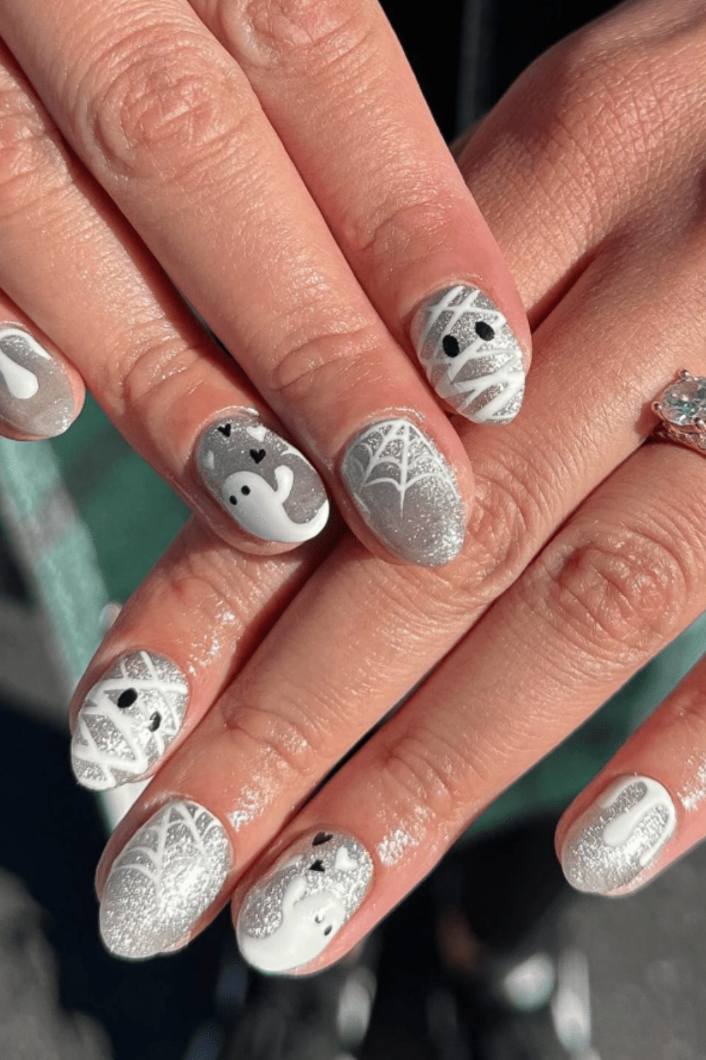Silver and white nails with intricate web and ghost designs