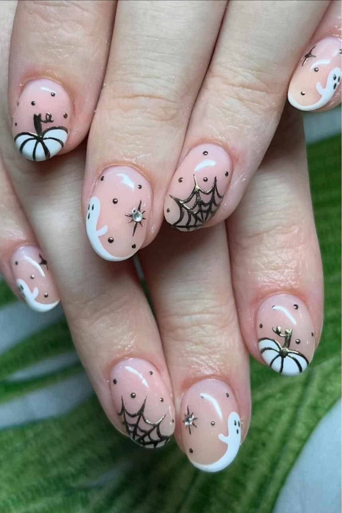 Nude nails with ghost and web designs