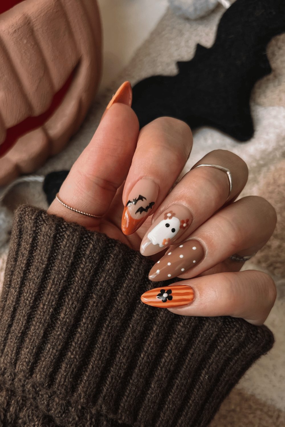 Orange and nude nails with Halloween motifs