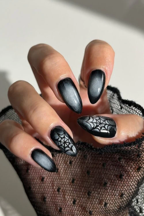 Black ombre nails with spider web designs